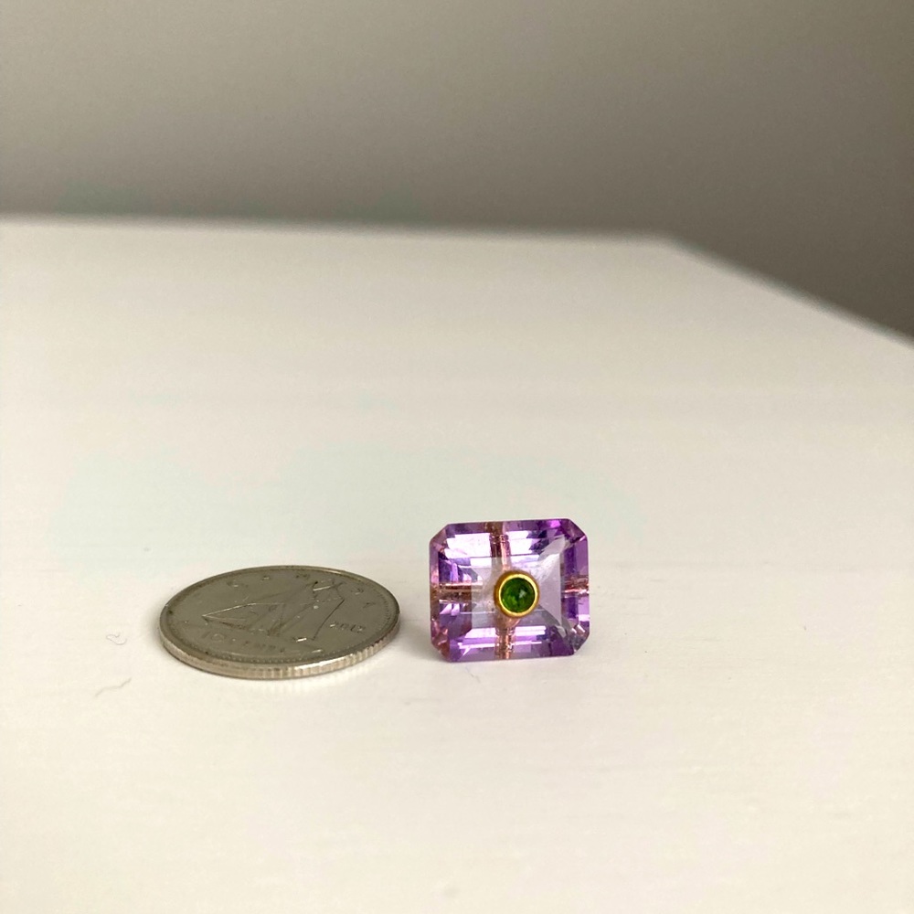 Amethyst charm with peridot inset.